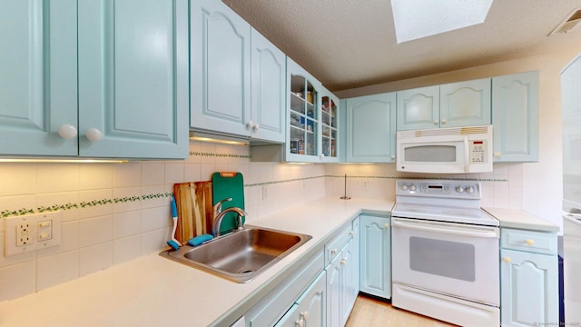 500 Prospect St Apt 4B, New Haven, CT 06511 - kitchen featuring white appliances, a sink, blue cabinetry, tasteful backsplash, and a textured ceiling