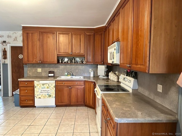 109 Central Ave, Wolcott, CT 06716 - kitchen featuring white appliances, a sink, brown cabinetry, and light tile patterned flooring