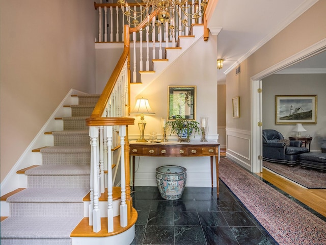 188 Bartlett Dr, Madison, CT 06443 - stairway with crown molding and a chandelier