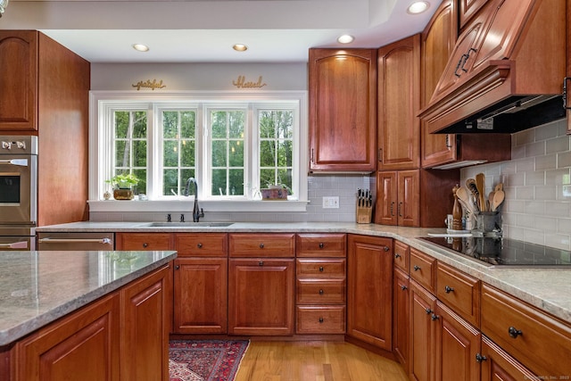 188 Bartlett Dr, Madison, CT 06443 - kitchen featuring black electric stovetop, a sink, brown cabinetry, and recessed lighting