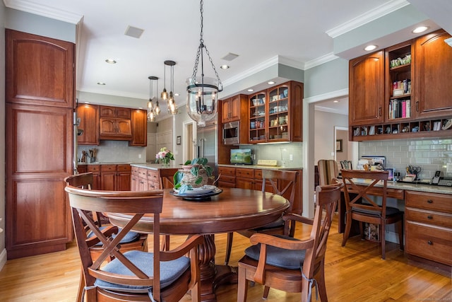 188 Bartlett Dr, Madison, CT 06443 - dining area featuring crown molding, light wood-style floors, recessed lighting, and a chandelier