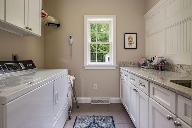188 Bartlett Dr, Madison, CT 06443 - laundry room with cabinet space, washer and dryer, dark tile patterned flooring, and baseboards