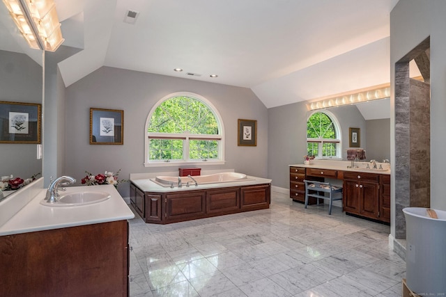 188 Bartlett Dr, Madison, CT 06443 - bathroom featuring lofted ceiling, plenty of natural light, marble look tiles, a garden tub, and two vanities