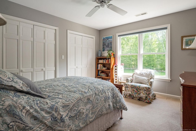 188 Bartlett Dr, Madison, CT 06443 - bedroom with multiple closets, light colored carpet, baseboards, and ceiling fan
