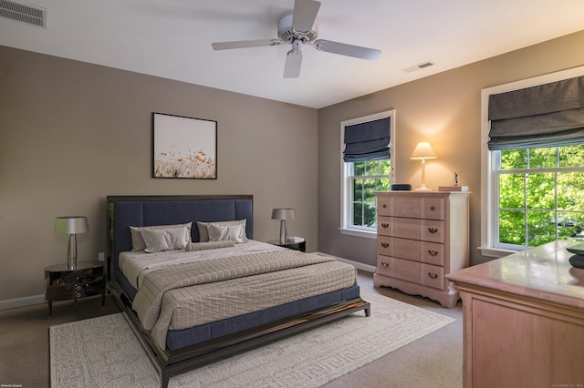 188 Bartlett Dr, Madison, CT 06443 - bedroom with light colored carpet, multiple windows, baseboards, and ceiling fan