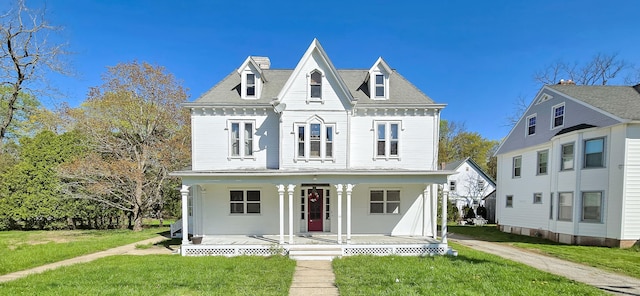 22 Perkins Ave, Norwich, CT 06360 - view of front of home with covered porch, a front lawn, and a chimney