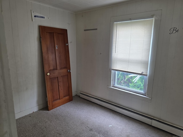42 Spring St, New London, CT 06320 - empty room featuring baseboard heating, carpet, and wood walls