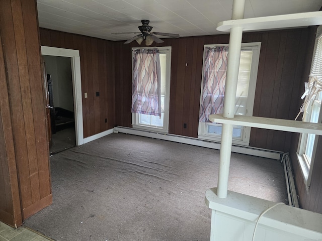42 Spring St, New London, CT 06320 - unfurnished dining area with plenty of natural light, carpet floors, wood walls, ceiling fan, and a baseboard radiator