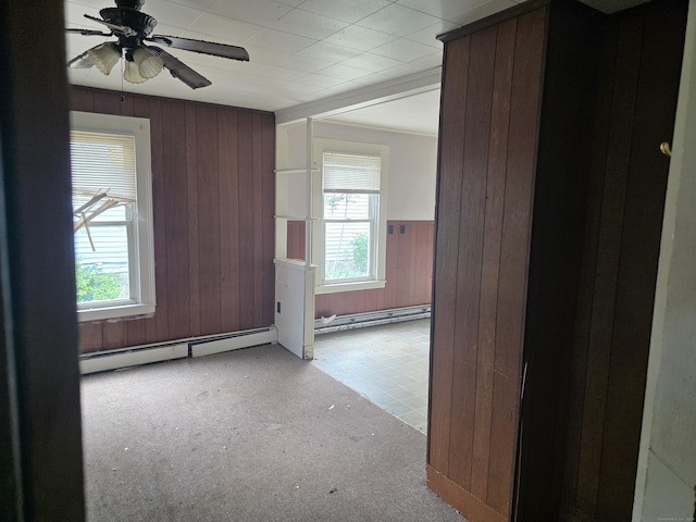 42 Spring St, New London, CT 06320 - entryway with plenty of natural light, a baseboard heating unit, ceiling fan, wood walls, and a wainscoted wall