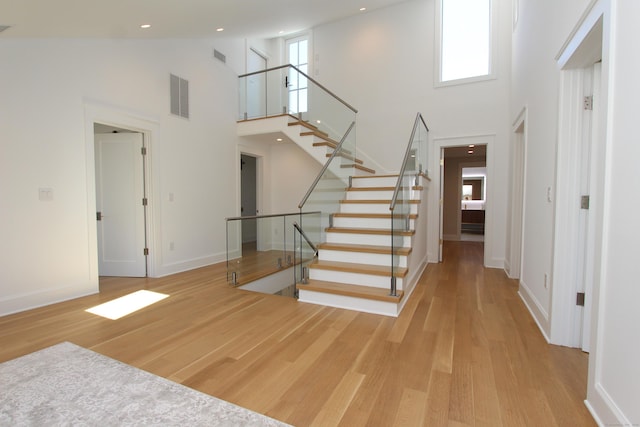 22 Apple Tree Trl, Westport, CT 06880 - entrance foyer with a towering ceiling, wood finished floors, stairway, baseboards, and recessed lighting