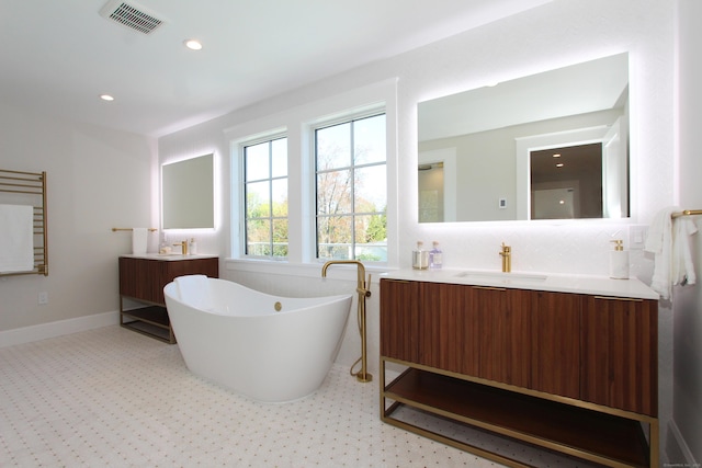 22 Apple Tree Trl, Westport, CT 06880 - full bath with two vanities, a freestanding bath, recessed lighting, and baseboards