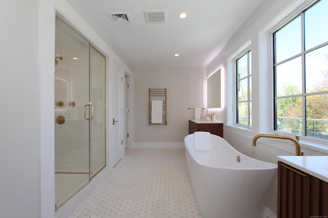 22 Apple Tree Trl, Westport, CT 06880 - full bathroom with vanity, a stall shower, a freestanding tub, recessed lighting, and baseboards