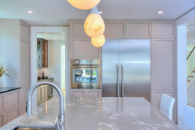22 Apple Tree Trl, Westport, CT 06880 - kitchen featuring appliances with stainless steel finishes, light stone countertops, recessed lighting, and glass insert cabinets