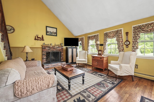 40 Fountainhead Rd, Plymouth, CT 06786 - living area featuring hardwood / wood-style flooring, baseboard heating, wainscoting, a brick fireplace, and high vaulted ceiling