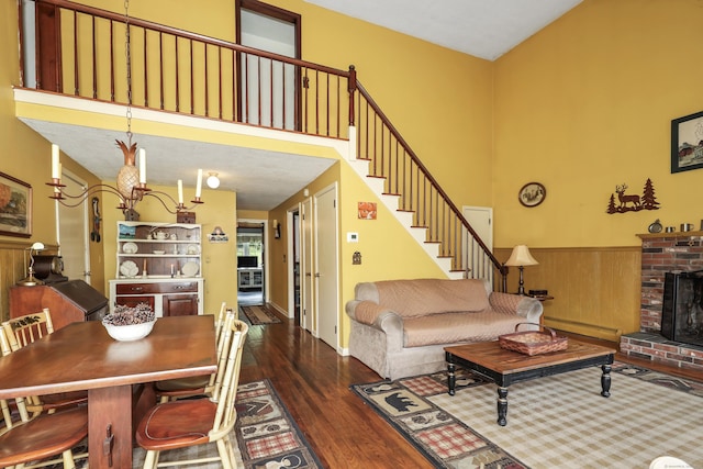 40 Fountainhead Rd, Plymouth, CT 06786 - living room featuring wood finished floors, stairs, a towering ceiling, a fireplace, and a baseboard heating unit