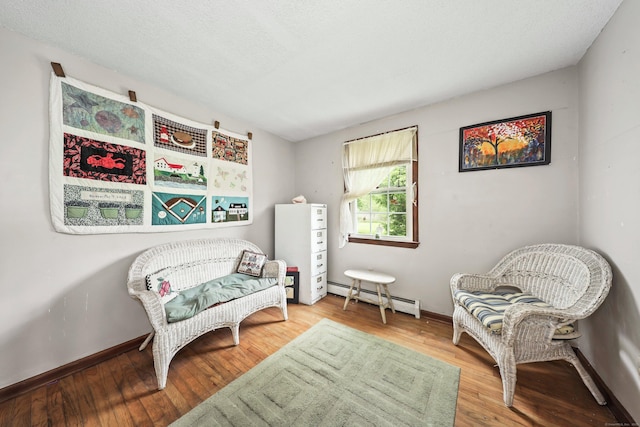 40 Fountainhead Rd, Plymouth, CT 06786 - sitting room with a baseboard radiator, wood finished floors, and baseboards