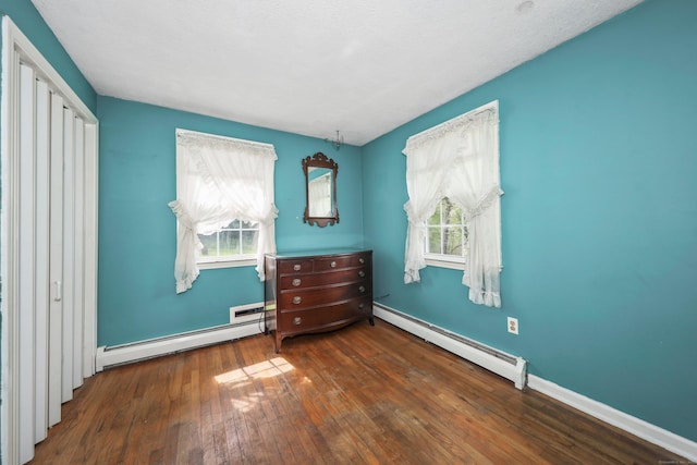 40 Fountainhead Rd, Plymouth, CT 06786 - bedroom with a baseboard heating unit, hardwood / wood-style floors, multiple windows, and baseboards