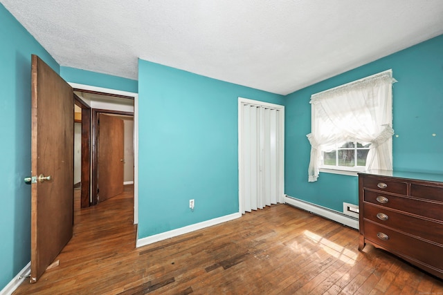 40 Fountainhead Rd, Plymouth, CT 06786 - unfurnished bedroom featuring baseboard heating, hardwood / wood-style flooring, and baseboards