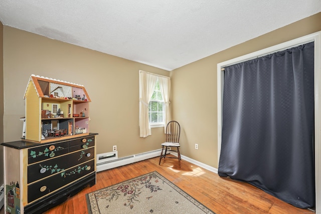 40 Fountainhead Rd, Plymouth, CT 06786 - living area featuring wood finished floors, baseboards, and a baseboard heating unit