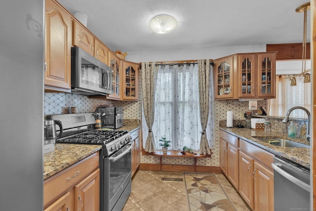 41 Farm Dr Unit 41, Farmington, CT 06032 - kitchen with stainless steel appliances, a sink, light stone countertops, and backsplash