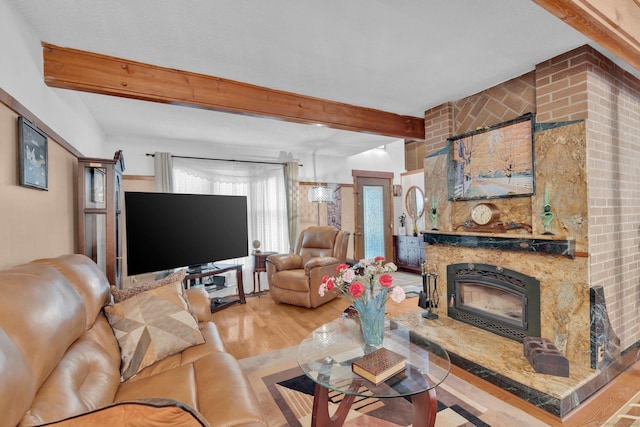 41 Farm Dr Unit 41, Farmington, CT 06032 - living area featuring beam ceiling, wood finished floors, and a fireplace with raised hearth