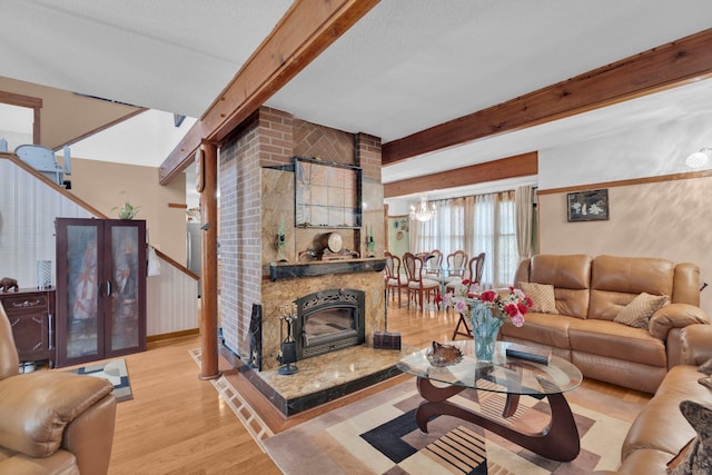 41 Farm Dr Unit 41, Farmington, CT 06032 - living area with beam ceiling, wood finished floors, a chandelier, and a fireplace