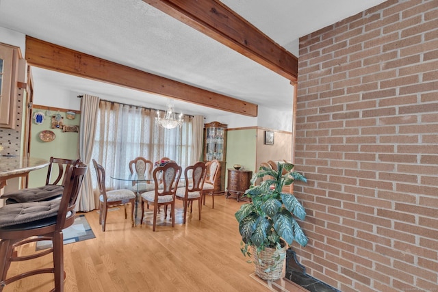 41 Farm Dr Unit 41, Farmington, CT 06032 - dining area featuring beamed ceiling, light wood finished floors, a chandelier, and brick wall