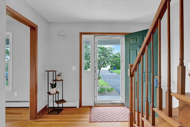 136 Windmill Hl, Wethersfield, CT 06109 - entrance foyer featuring light wood finished floors, baseboard heating, stairs, and baseboards