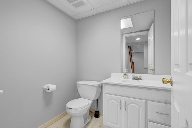 136 Windmill Hl, Wethersfield, CT 06109 - bathroom with toilet, vanity, tile patterned flooring, baseboards, and a drop ceiling