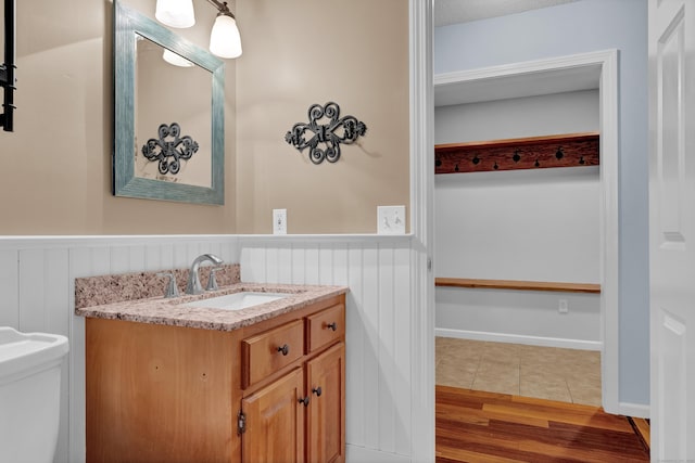 136 Windmill Hl, Wethersfield, CT 06109 - half bath with wainscoting, vanity, toilet, and tile patterned flooring