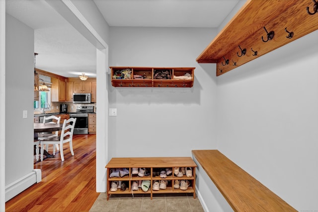 136 Windmill Hl, Wethersfield, CT 06109 - mudroom with a chandelier, a sink, baseboard heating, and light wood-style flooring