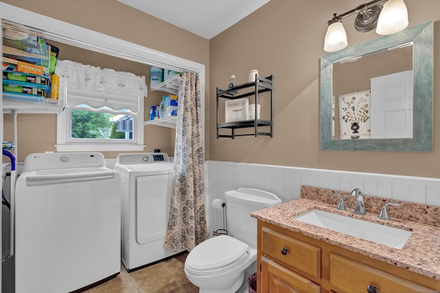 136 Windmill Hl, Wethersfield, CT 06109 - full bath with washer and clothes dryer, a wainscoted wall, toilet, vanity, and tile patterned flooring