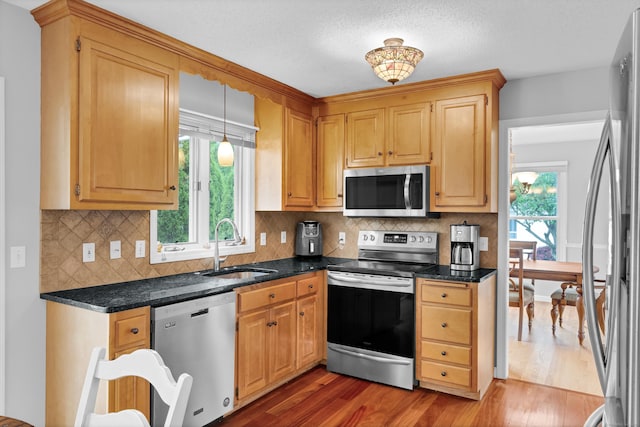 136 Windmill Hl, Wethersfield, CT 06109 - kitchen featuring appliances with stainless steel finishes, a sink, wood finished floors, and tasteful backsplash