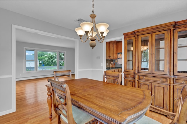 136 Windmill Hl, Wethersfield, CT 06109 - dining room featuring a chandelier, light wood-type flooring, and a baseboard radiator