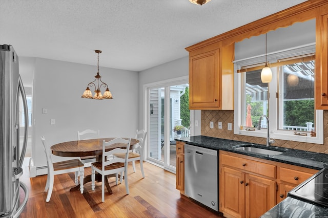 136 Windmill Hl, Wethersfield, CT 06109 - kitchen featuring stainless steel appliances, wood finished floors, a sink, tasteful backsplash, and a chandelier