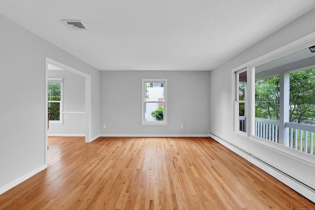 136 Windmill Hl, Wethersfield, CT 06109 - empty room with baseboard heating, light wood-type flooring, and baseboards