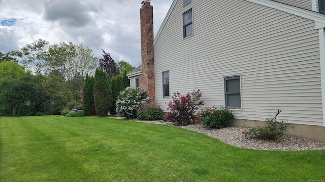 136 Windmill Hl, Wethersfield, CT 06109 - view of side of home with a lawn and a chimney