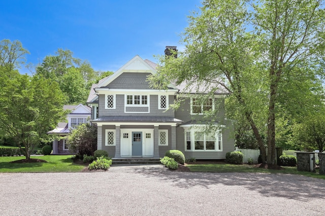 67 Peaceable St, Ridgefield, CT 06877 - shingle-style home featuring a chimney, fence, a porch, metal roof, and a standing seam roof