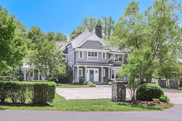 67 Peaceable St, Ridgefield, CT 06877 - shingle-style home with a chimney, a porch, a standing seam roof, metal roof, and a front lawn