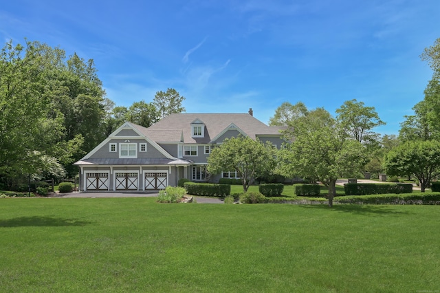 67 Peaceable St, Ridgefield, CT 06877 - view of front facade with a front yard, a garage, and asphalt driveway