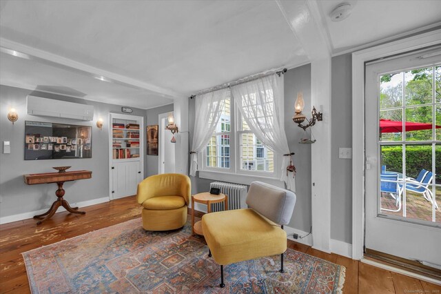 11 Liberty St, Clinton, CT 06413 - sitting room featuring radiator, hardwood / wood-style floors, an AC wall unit, and baseboards
