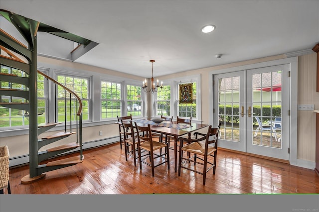 dining area with french doors, a chandelier, hardwood / wood-style floors, a baseboard heating unit, and recessed lighting
