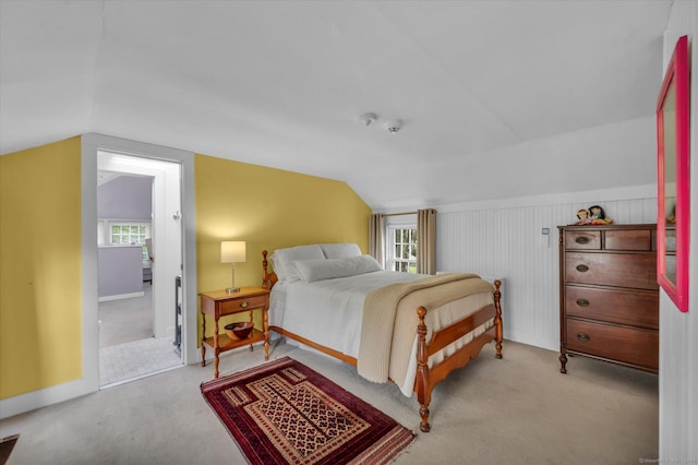bedroom with lofted ceiling, carpet, and baseboards