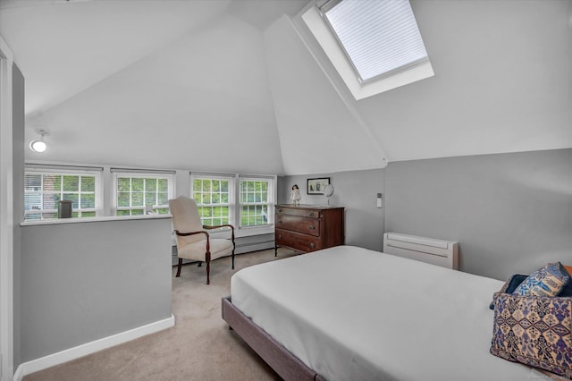 carpeted bedroom featuring lofted ceiling, a skylight, multiple windows, and baseboards