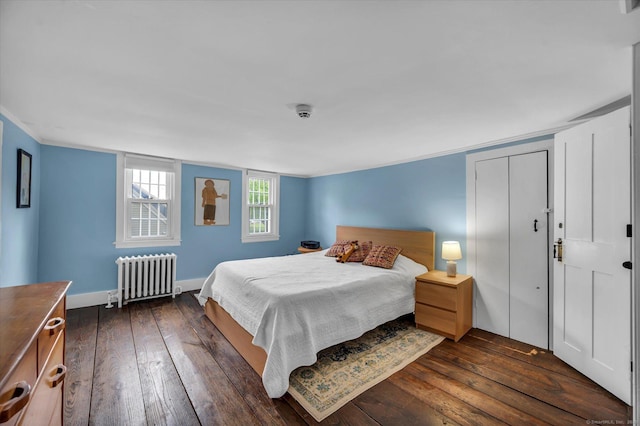 bedroom featuring radiator heating unit and dark wood-style floors