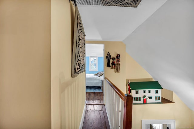 staircase with hardwood / wood-style floors and lofted ceiling