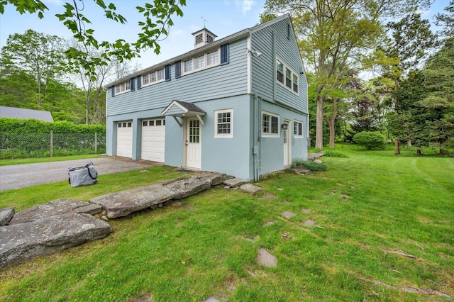 view of front facade with driveway, a garage, a front lawn, and stucco siding
