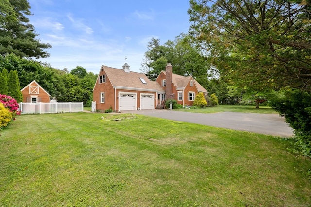 717 Center St, Manchester, CT 06040 - view of front of property featuring a garage, a chimney, and asphalt driveway