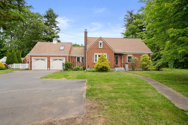 717 Center St, Manchester, CT 06040 - view of front of property with asphalt driveway, a garage, and a chimney