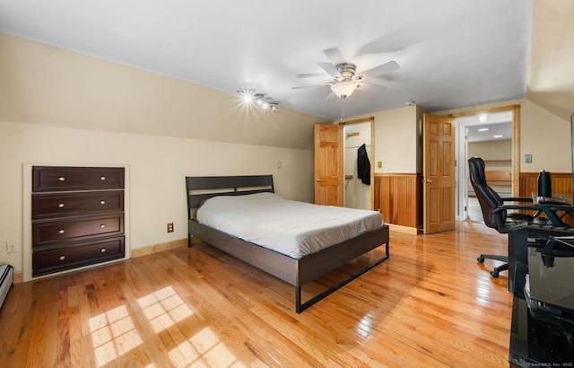 717 Center St, Manchester, CT 06040 - bedroom featuring light wood-type flooring, wainscoting, vaulted ceiling, an office area, and wood walls